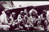 Airmen crouching under plane