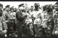 General Eisenhower - General Dwight D. Eisenhower, Supreme Commander of the Allied Expeditionary Force, speaks with Lieutenant Wallace C. Strobel, a paratrooper in the 101st Airborne Division, at Greenham Common airfield on the evening of June 5, 1944. Shortly after General Eisenhower’s visit, the men of the 101st boarded C-47 troop transports and departed for Normandy.