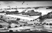 Allied Armada - The Allied armada disgorges its cargo on Omaha beach.  LSTs have beached themselves and are unloading vehicles as freighters stand further off and are unloaded by LVCPs and DUKWs. Gift of Jeffery M. Cole and Mary Egan, The National WWII Museum Inc., 2002.119