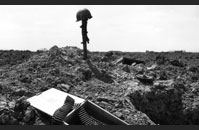 Pointe du Hoc - A US helmet sits atop a captured German machine gun, marking the location at Pointe-du-Hoc of fallen comrades, casualties of June 6. Although there is no “official” figure, Allied casualties on June 6 are estimated at 10,000. The number of Axis casualties is estimated between 4,000 and 9,000 men. Image courtesy of National Archives, W+C#1045